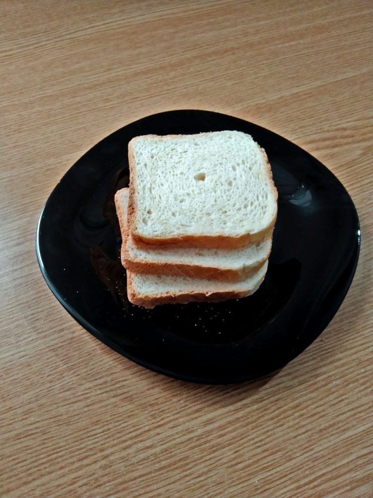 3 slices of bread on black plate on a table