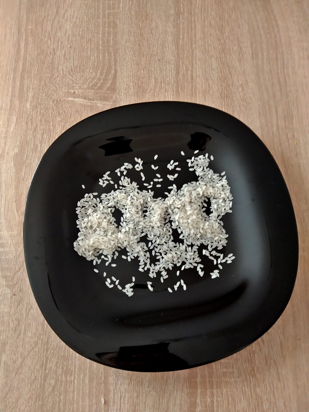 raw rice on a white plate on a table